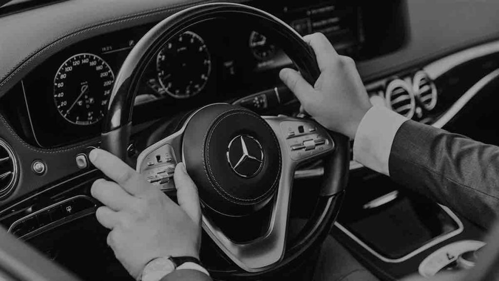 Driver Keeps Hands on Mercedes Car Steering Wheel